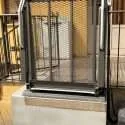 Low-rise wheelchair platform lift bridging entry steps at a residential porch