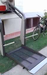 Outdoor Wheelchair Platform Lift: Compact, Durable, and Easy to Install Open platform of a wheelchair lift with non-slip mesh surface and fold-up access ramp