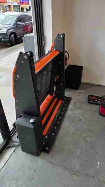 Outdoor Wheelchair Platform Lift: Compact, Durable, and Easy to Install Platform lift installed at a glazed building entrance, platform lowered ready for wheelchair access