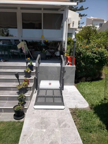 Residential wheelchair platform lift installed at home entrance for step-free access