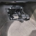 Three pedals dual control driving instructor system installed in manual vehicle footwell with brake, accelerator and clutch pedals
